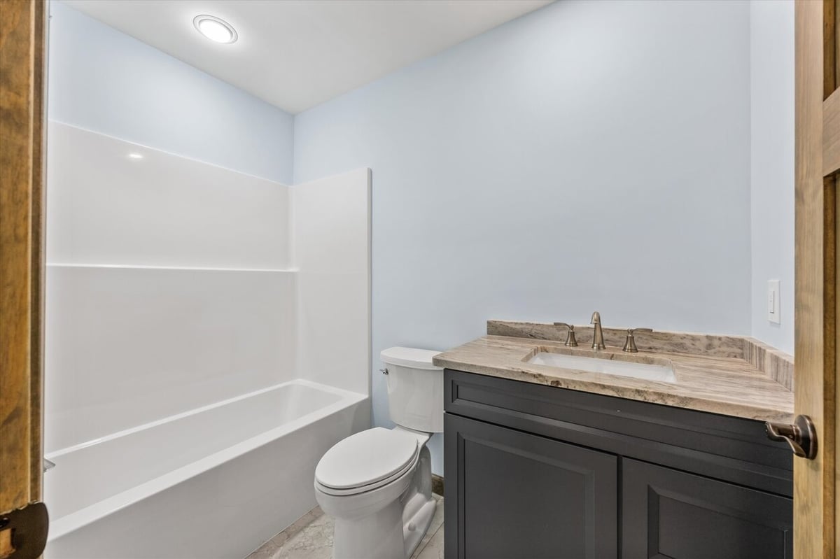 Full bathroom with dark vanity and bathtub in Friendsville Custom Home in Knoxville, TN