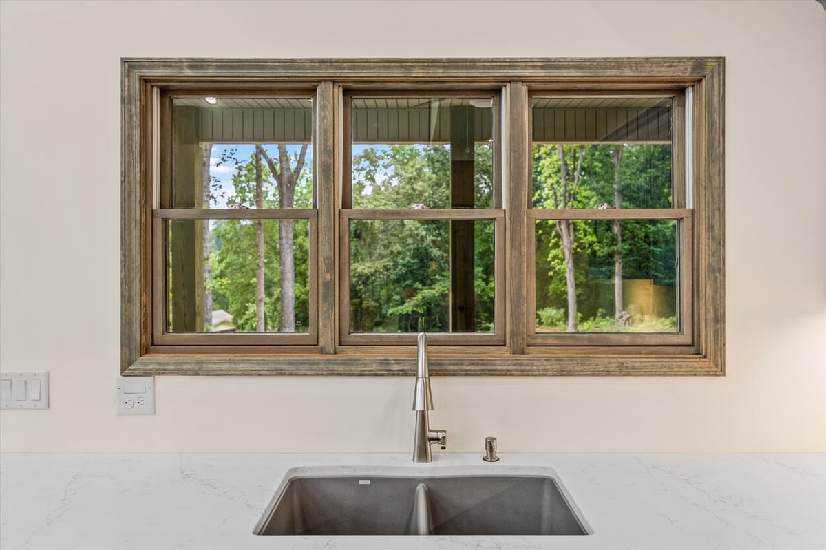 Kitchen sink with wide window overlooking wooded lot in Friendsville Custom Home in Knoxville, TN