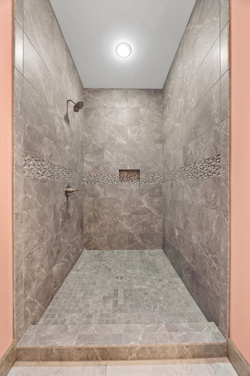 Luxurious stone tile shower interior in Friendsville Custom Home in Knoxville, TN