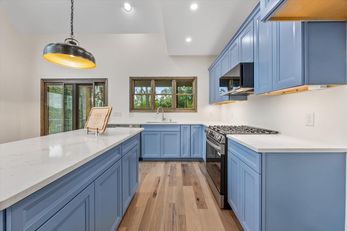 Open-concept kitchen with blue cabinetry and large island in Friendsville Custom Home in Knoxville, TN