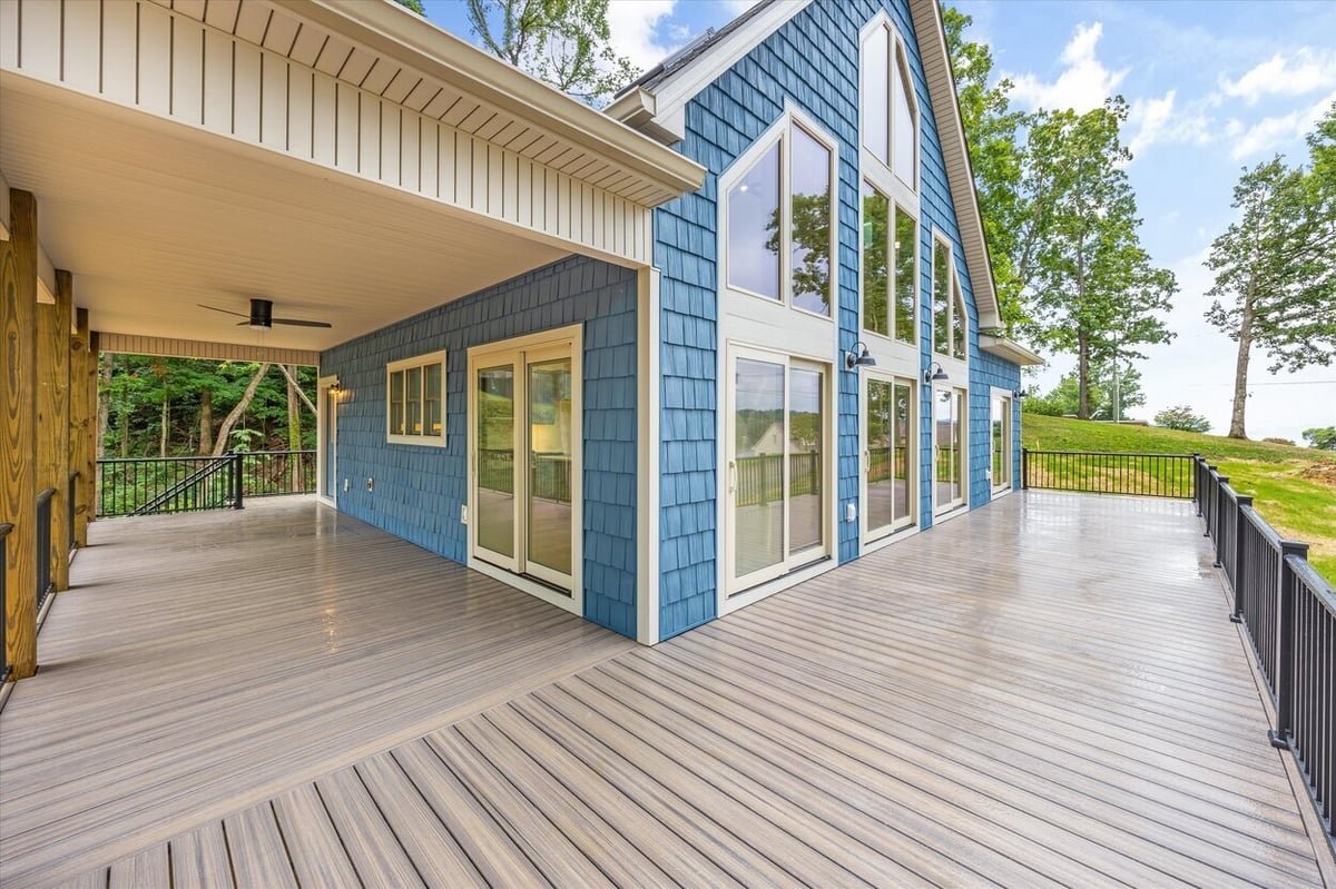 Side angle of custom deck and blue exterior of Friendsville Custom Home in Knoxville, TN