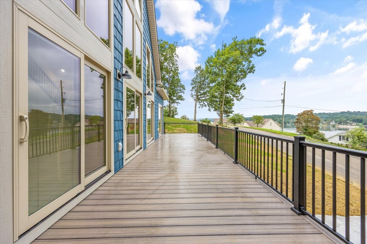 Upper deck with black railing overlooking scenic views at Friendsville Custom Home in Knoxville, TN