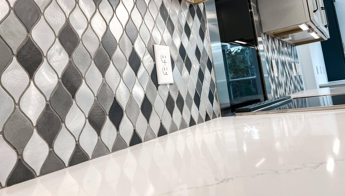 Close-up of silver and black diamond-pattern backsplash tiles in a custom home in Knoxville, TN by Debuty Builders, Inc.