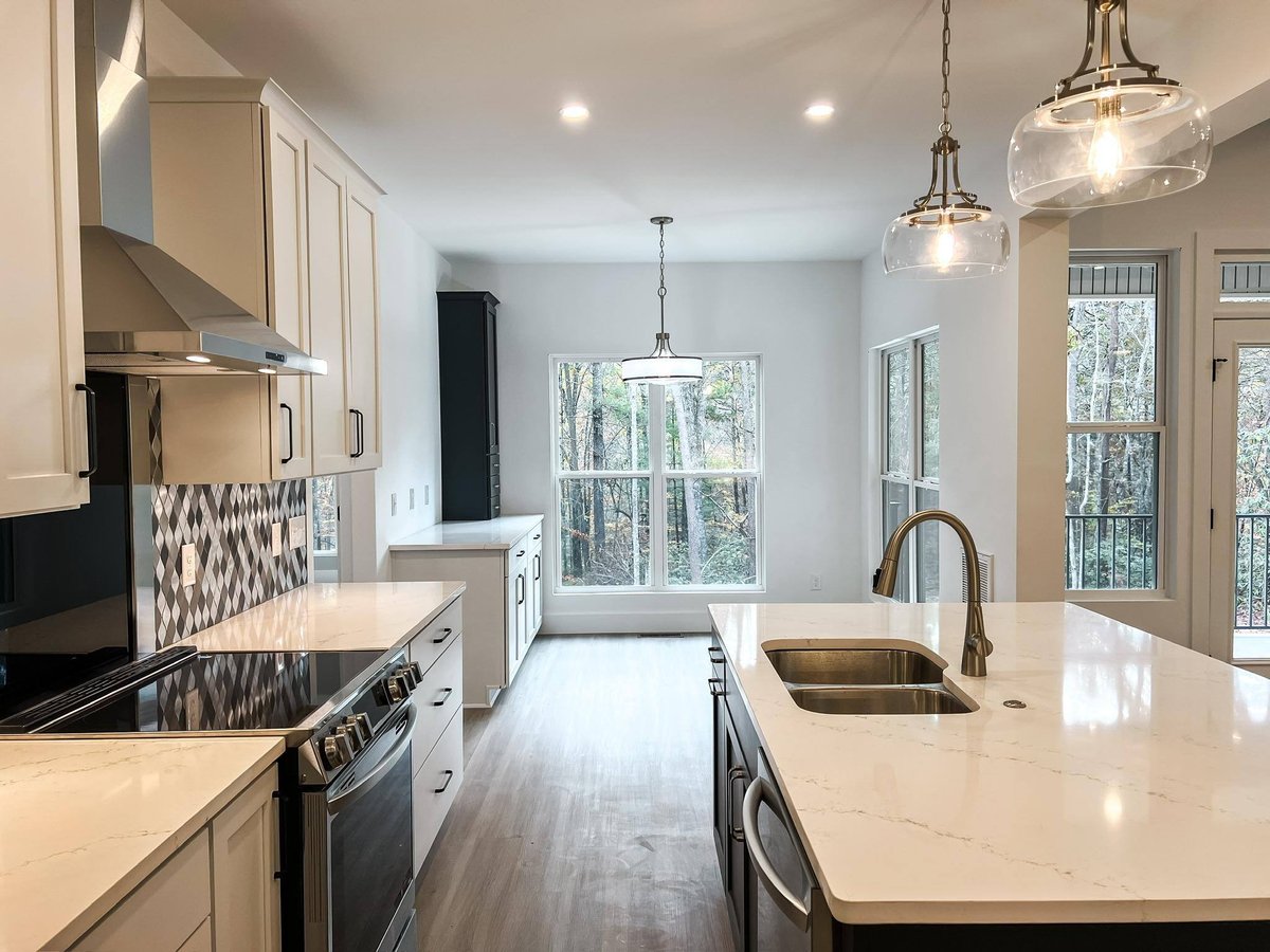 Close-up of the kitchen island with quartz countertops, under-mount sink, and pendant lighting in a custom home in Knoxville, TN by Debuty Builders, Inc.