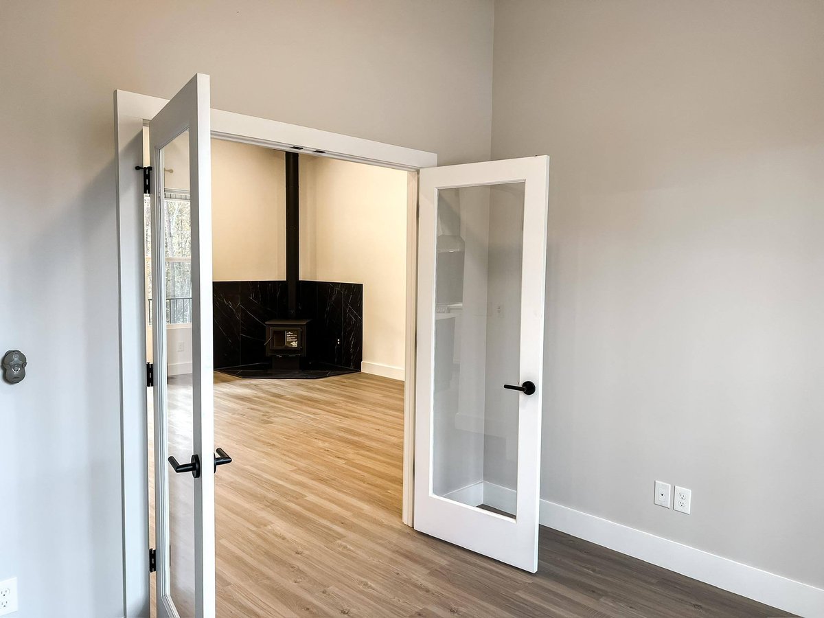 Interior space with French doors leading to a room with a wood-burning stove in a custom home in Knoxville, TN by Debuty Builders, Inc.