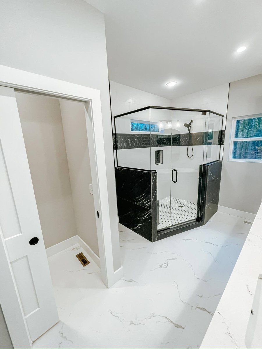 Luxury walk-in shower with black marble and hexagonal accent tiles in a custom home in Knoxville, TN by Debuty Builders, Inc.