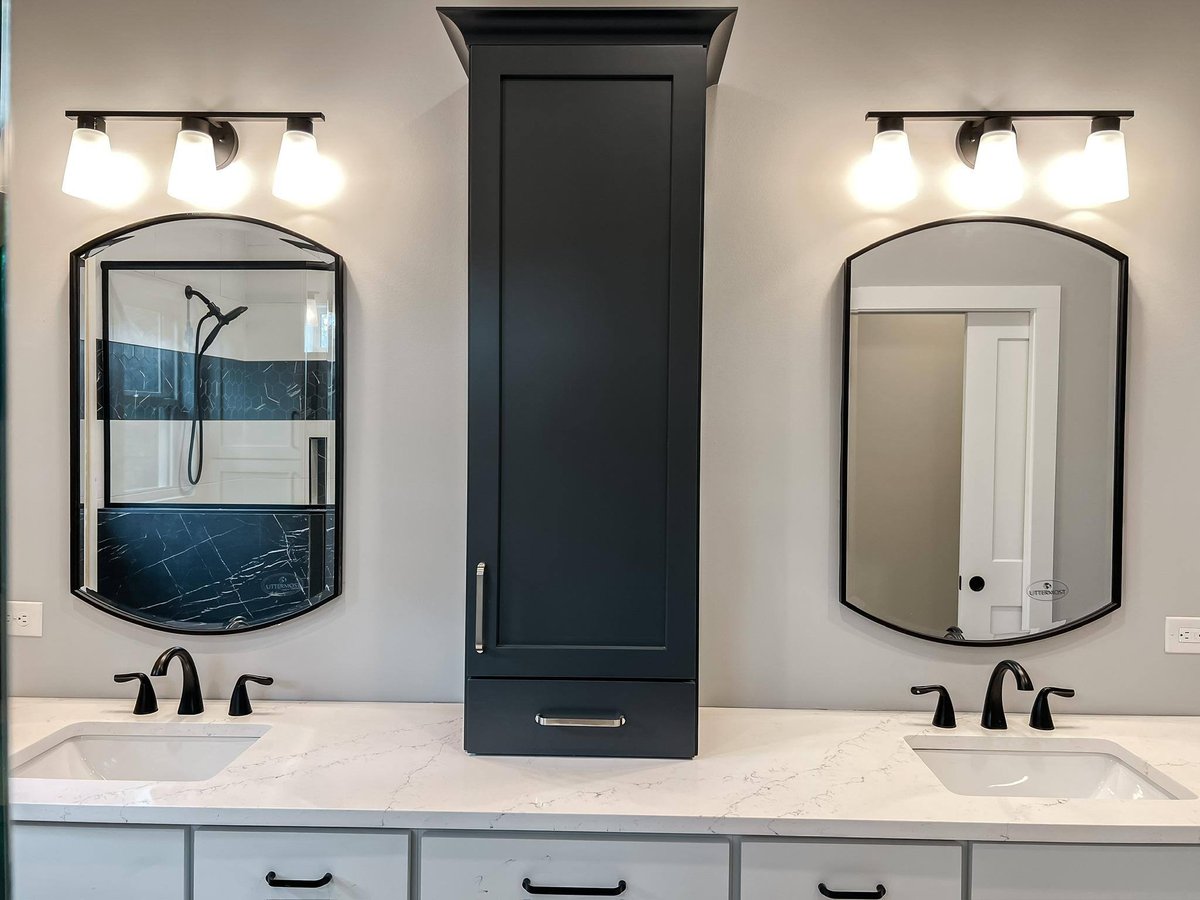 Master bathroom featuring a double vanity with black faucets, quartz countertops, and framed mirrors in a custom home in Knoxville, TN by Debuty Builders, Inc.